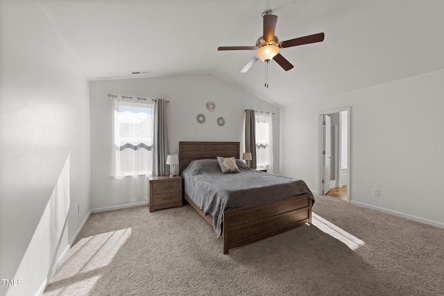 carpeted bedroom with ceiling fan and vaulted ceiling