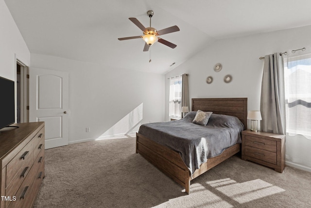 carpeted bedroom featuring ceiling fan, vaulted ceiling, and multiple windows