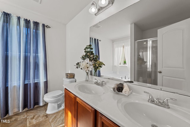 bathroom with vanity, a shower with shower door, and toilet