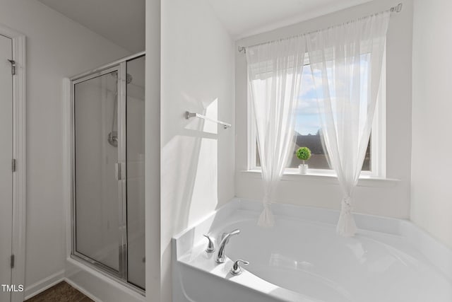 bathroom featuring separate shower and tub