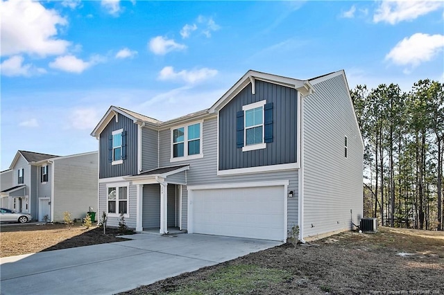 view of front of house featuring a garage and central AC