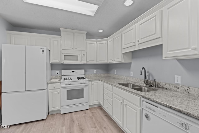 kitchen with a textured ceiling, white appliances, sink, light hardwood / wood-style flooring, and white cabinetry