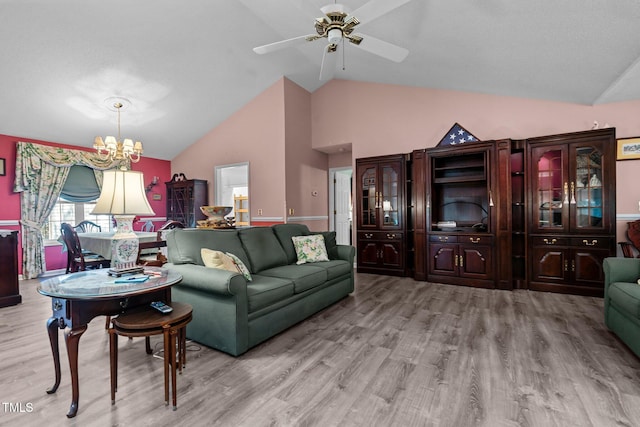 living room with high vaulted ceiling, ceiling fan with notable chandelier, and light wood-type flooring