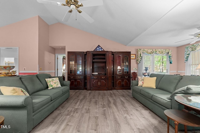 living room featuring ceiling fan, light hardwood / wood-style floors, and high vaulted ceiling