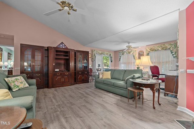 living room featuring high vaulted ceiling, light hardwood / wood-style flooring, and ceiling fan