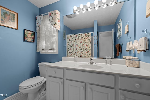 bathroom with a textured ceiling, vanity, toilet, and walk in shower