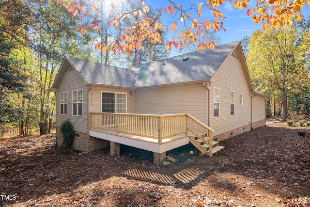 back of house featuring a wooden deck