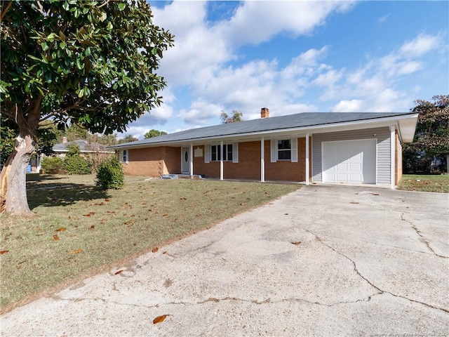 ranch-style house with a front yard and a garage