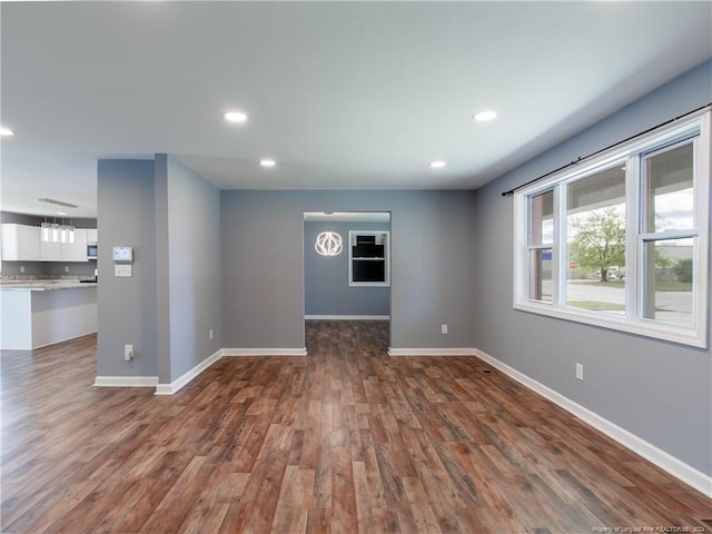 unfurnished room with dark wood-type flooring