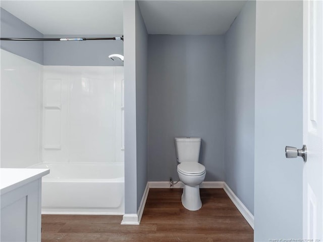 full bathroom with vanity, toilet, wood-type flooring, and shower / washtub combination