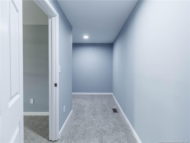 hallway with light colored carpet