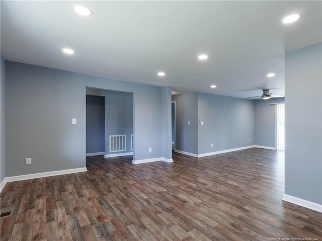 unfurnished room with ceiling fan and dark wood-type flooring