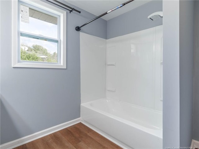 bathroom with hardwood / wood-style floors and shower / bathing tub combination