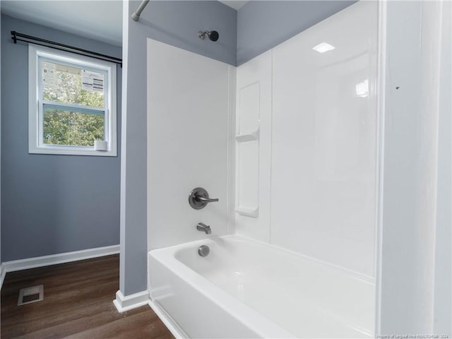 bathroom featuring bathtub / shower combination and hardwood / wood-style flooring