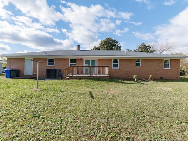 rear view of house featuring central AC, a deck, and a lawn