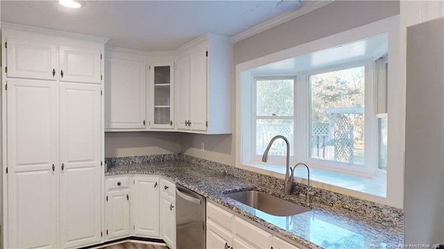 3327 Seven Mountain Dr, Fayetteville, NC 28306 - kitchen with stainless steel dishwasher, a sink, light stone counters, glass insert cabinets, and white cabinetry