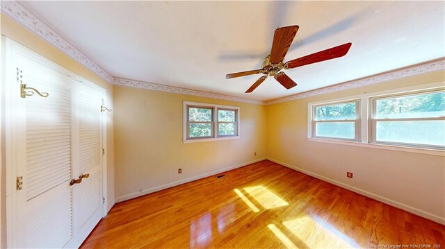 3327 Seven Mountain Dr, Fayetteville, NC 28306 - unfurnished bedroom with baseboards, a ceiling fan, visible vents, and light wood-type flooring
