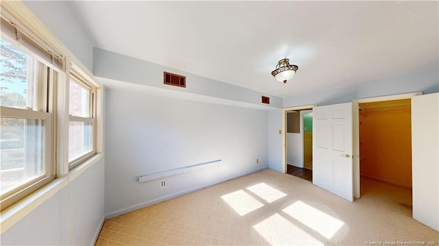3327 Seven Mountain Dr, Fayetteville, NC 28306 - unfurnished bedroom with baseboards, multiple windows, carpet flooring, and visible vents