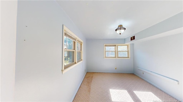3327 Seven Mountain Dr, Fayetteville, NC 28306 - spare room featuring baseboards and light colored carpet