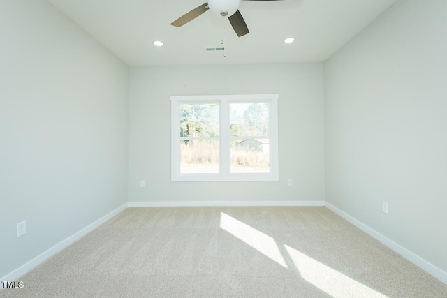 spare room with baseboards, visible vents, light colored carpet, and recessed lighting