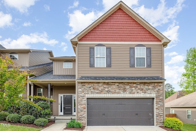 craftsman-style home with roof with shingles, stone siding, covered porch, concrete driveway, and an attached garage