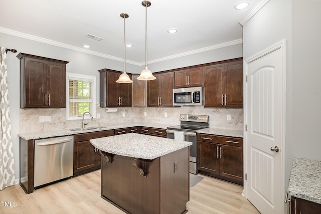 kitchen featuring dark brown cabinets, visible vents, stainless steel appliances, and a sink