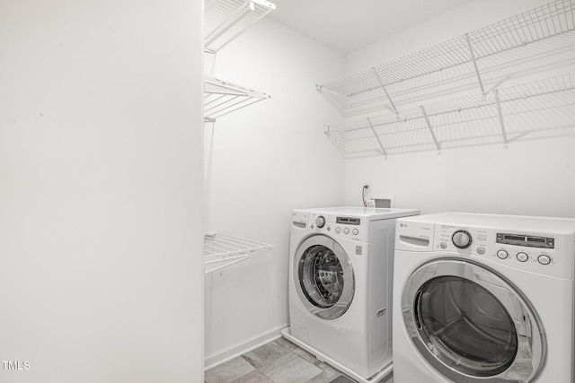 washroom with separate washer and dryer, baseboards, and laundry area