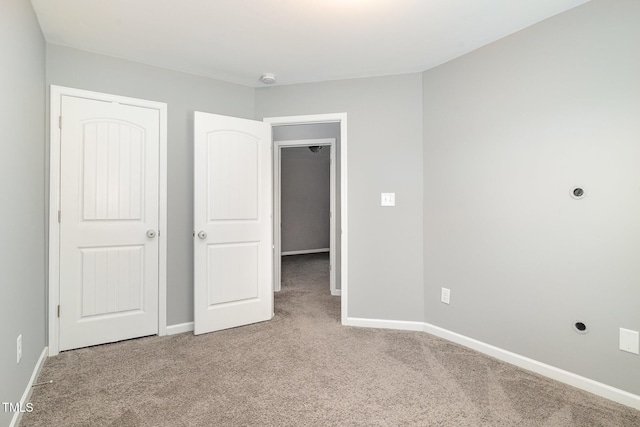 unfurnished bedroom featuring baseboards and carpet floors