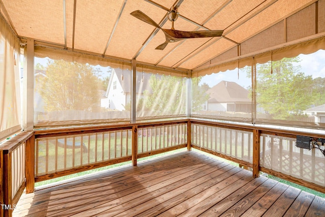 unfurnished sunroom with ceiling fan