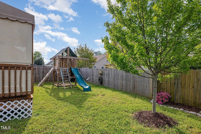 view of yard with a fenced backyard and a playground