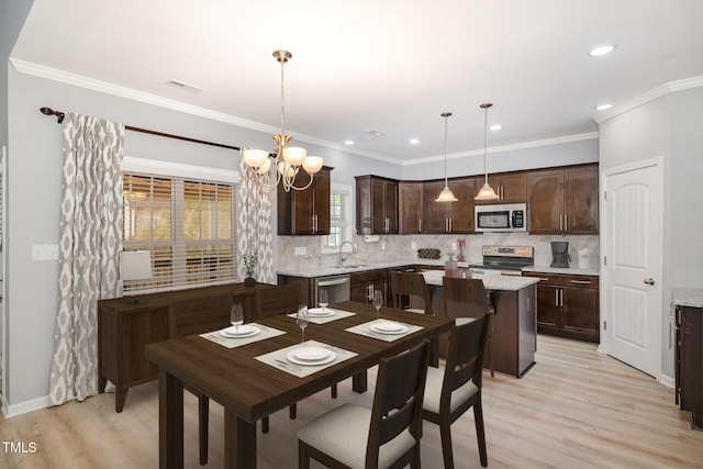 dining space with light wood finished floors, an inviting chandelier, recessed lighting, and crown molding
