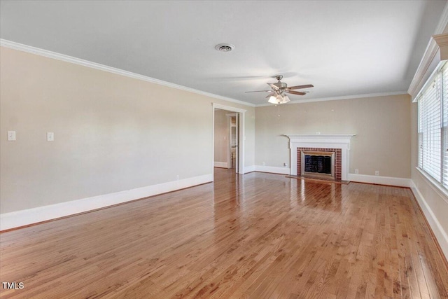 unfurnished living room with a fireplace, ceiling fan, light wood-type flooring, and ornamental molding