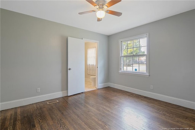 spare room featuring ceiling fan and dark wood-type flooring