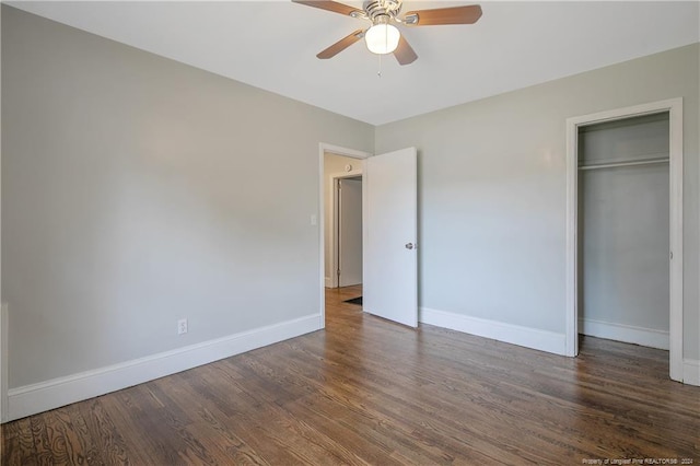 unfurnished bedroom with ceiling fan, a closet, and dark wood-type flooring