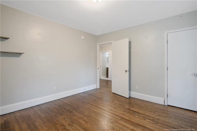 spare room with dark wood-type flooring