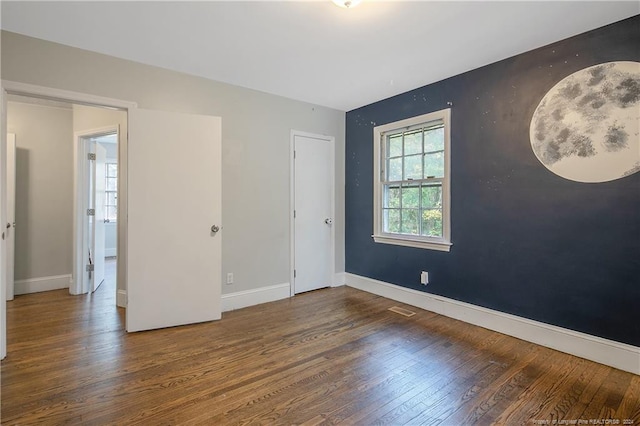 unfurnished bedroom featuring dark wood-type flooring