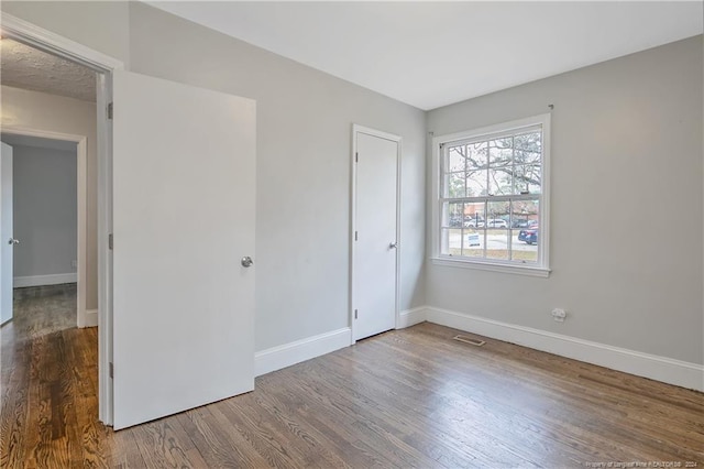 unfurnished bedroom featuring wood-type flooring