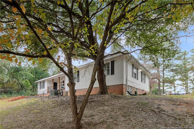 view of side of home featuring cooling unit