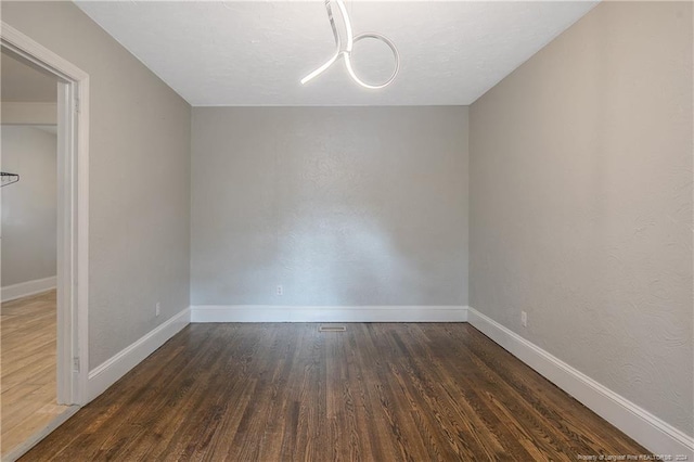 spare room with dark hardwood / wood-style flooring