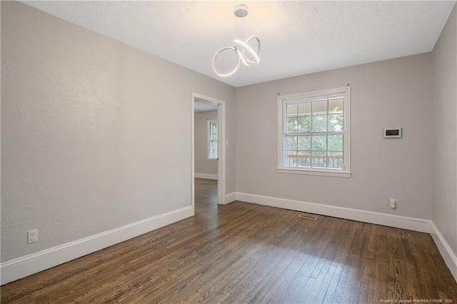 empty room featuring dark hardwood / wood-style flooring