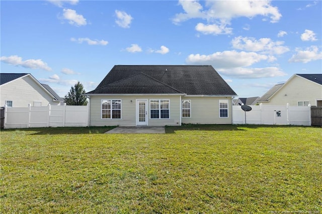 rear view of property with a patio and a lawn