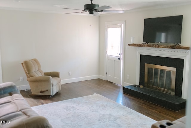 living room with wood-type flooring, ceiling fan, and crown molding