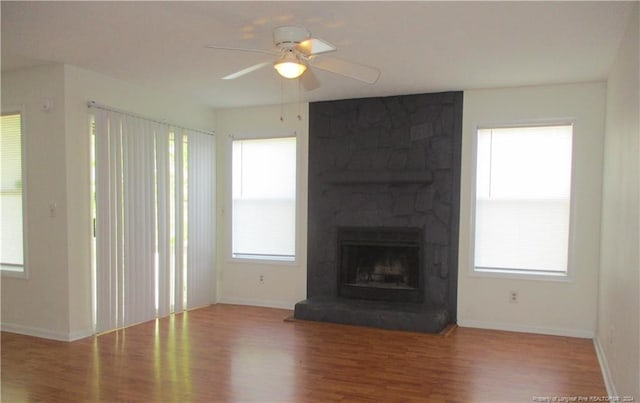 unfurnished living room with hardwood / wood-style floors, plenty of natural light, and ceiling fan