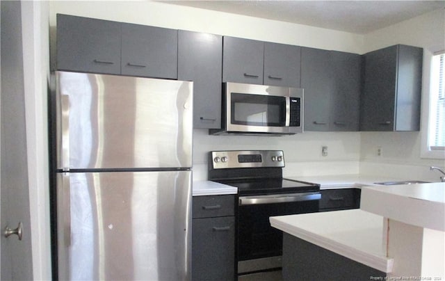 1014 Brookhollow Dr Unit 4, Fayetteville, NC 28314 - kitchen featuring appliances with stainless steel finishes, gray cabinets, and light countertops