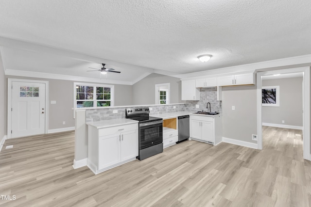 kitchen featuring sink, decorative backsplash, white cabinets, and appliances with stainless steel finishes