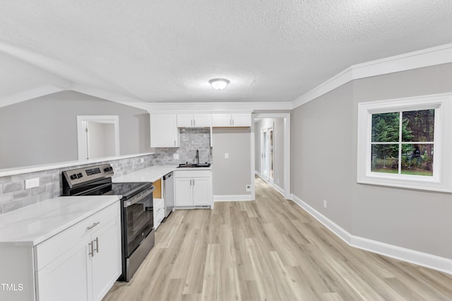 kitchen with tasteful backsplash, white cabinetry, appliances with stainless steel finishes, and sink