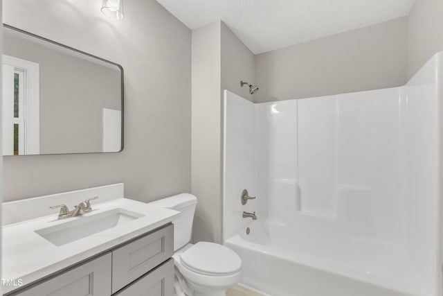 full bathroom featuring vanity, a textured ceiling, toilet, and washtub / shower combination