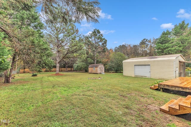 view of yard with a wooden deck and a storage unit