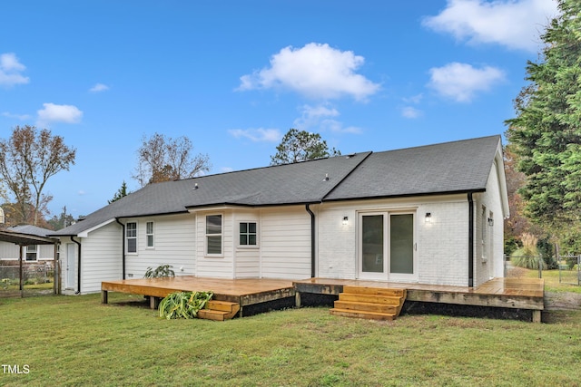 rear view of property with a yard and a deck