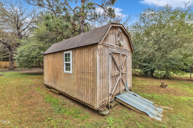 view of outbuilding with a lawn